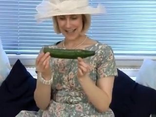 Mature housewife drills a cucumber